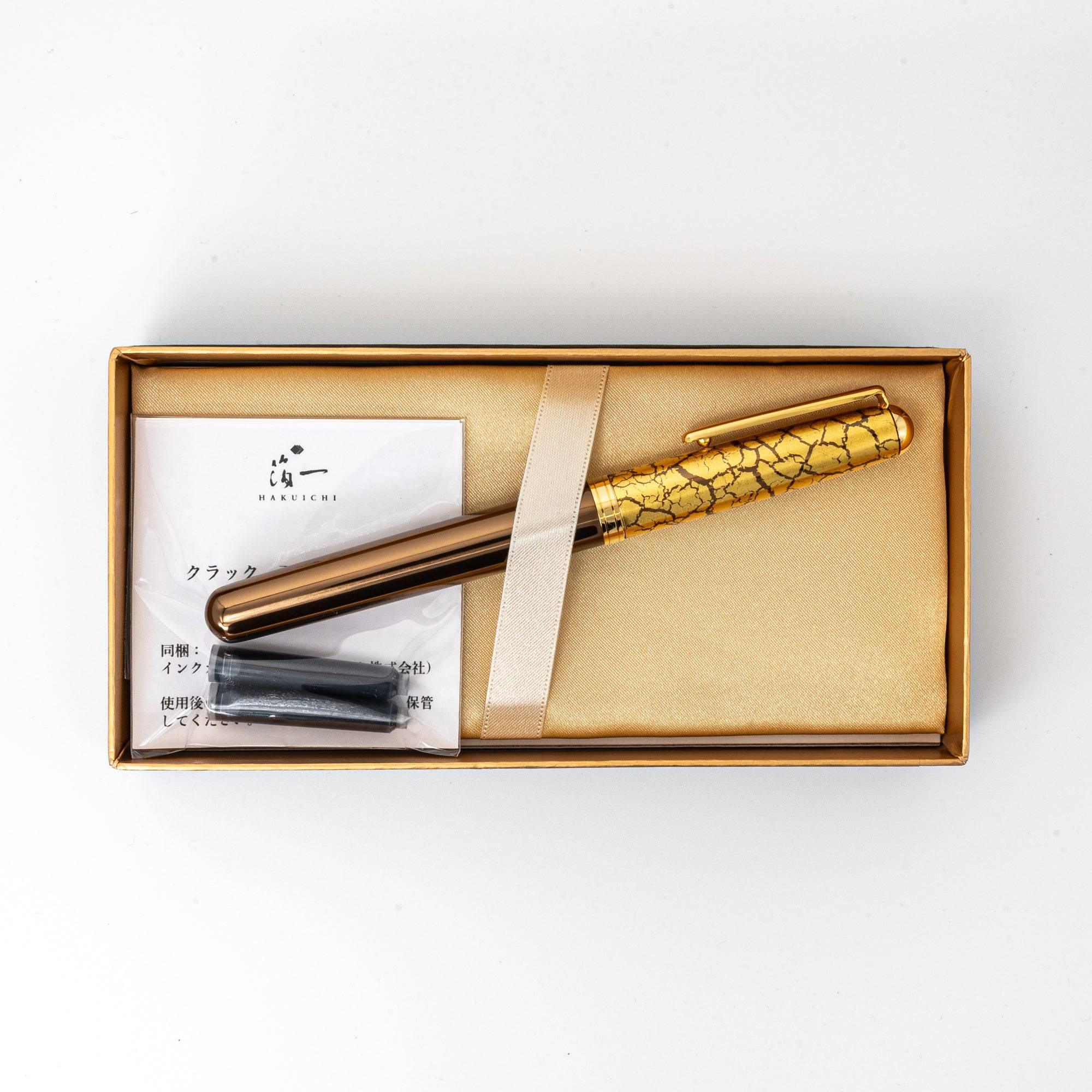 Uncapped brown fountain pen displaying full barrel length with intricate gold leaf crackle pattern design