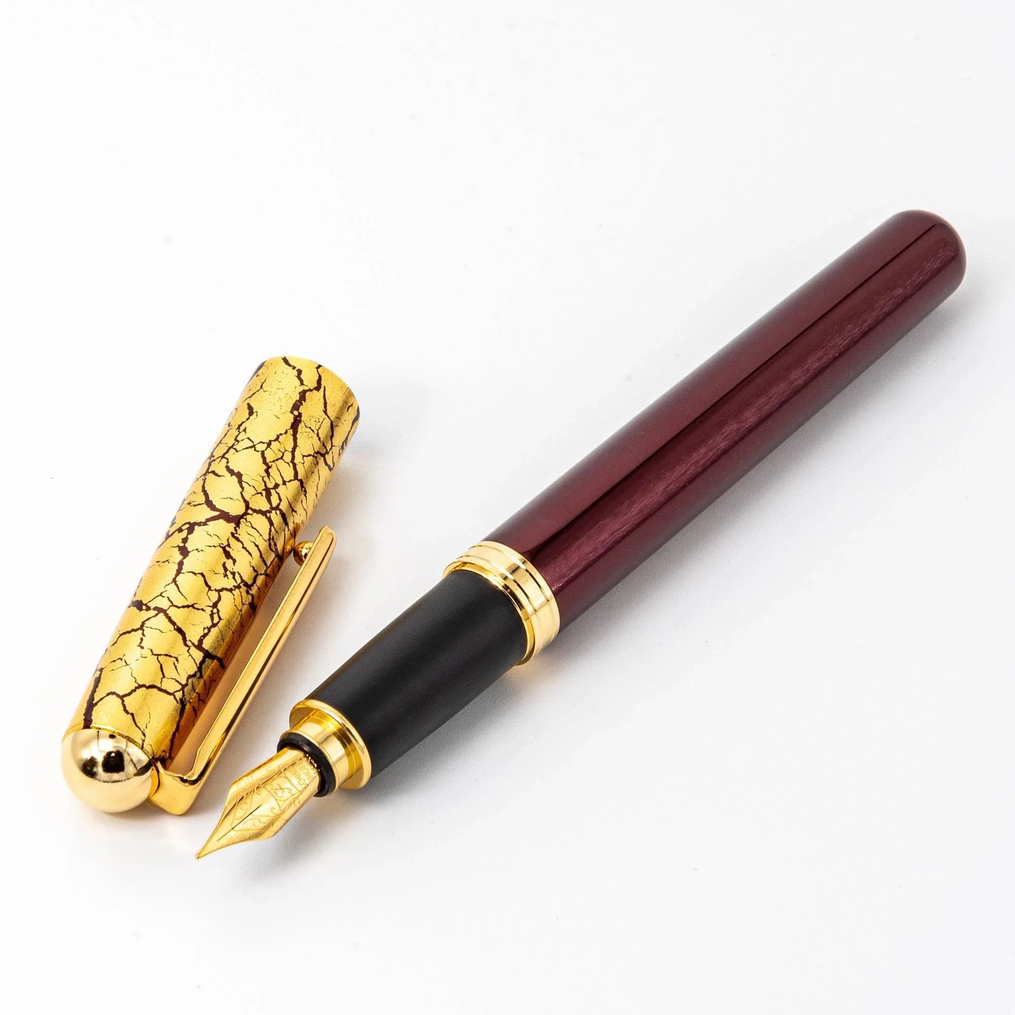 Wine red capped fountain pen with gold crackle pattern, Japanese lacquer craft detail, dark burgundy barrel