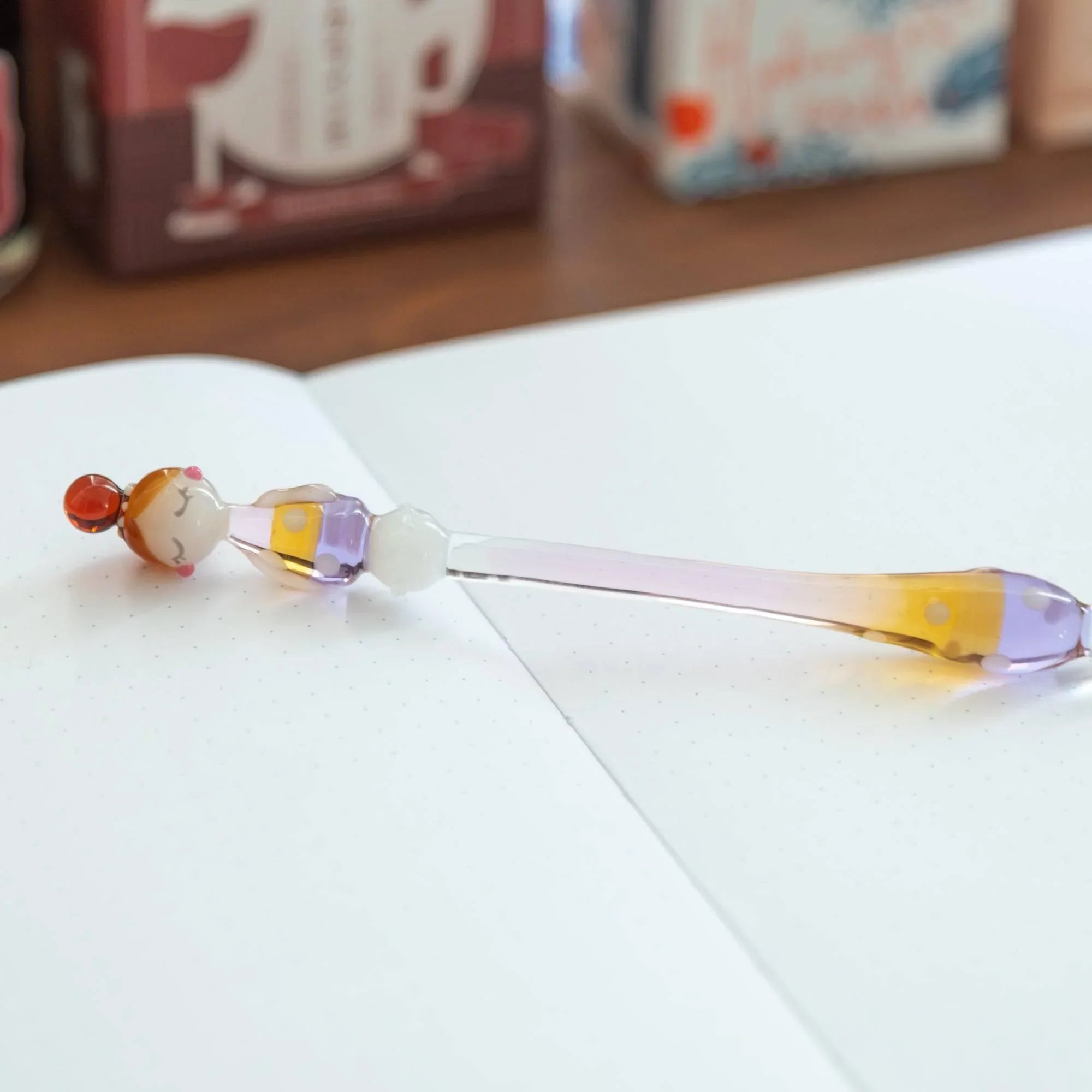Marun-Chan polka-dot glass dip pen with yellow and purple spotted glass handle design on white background