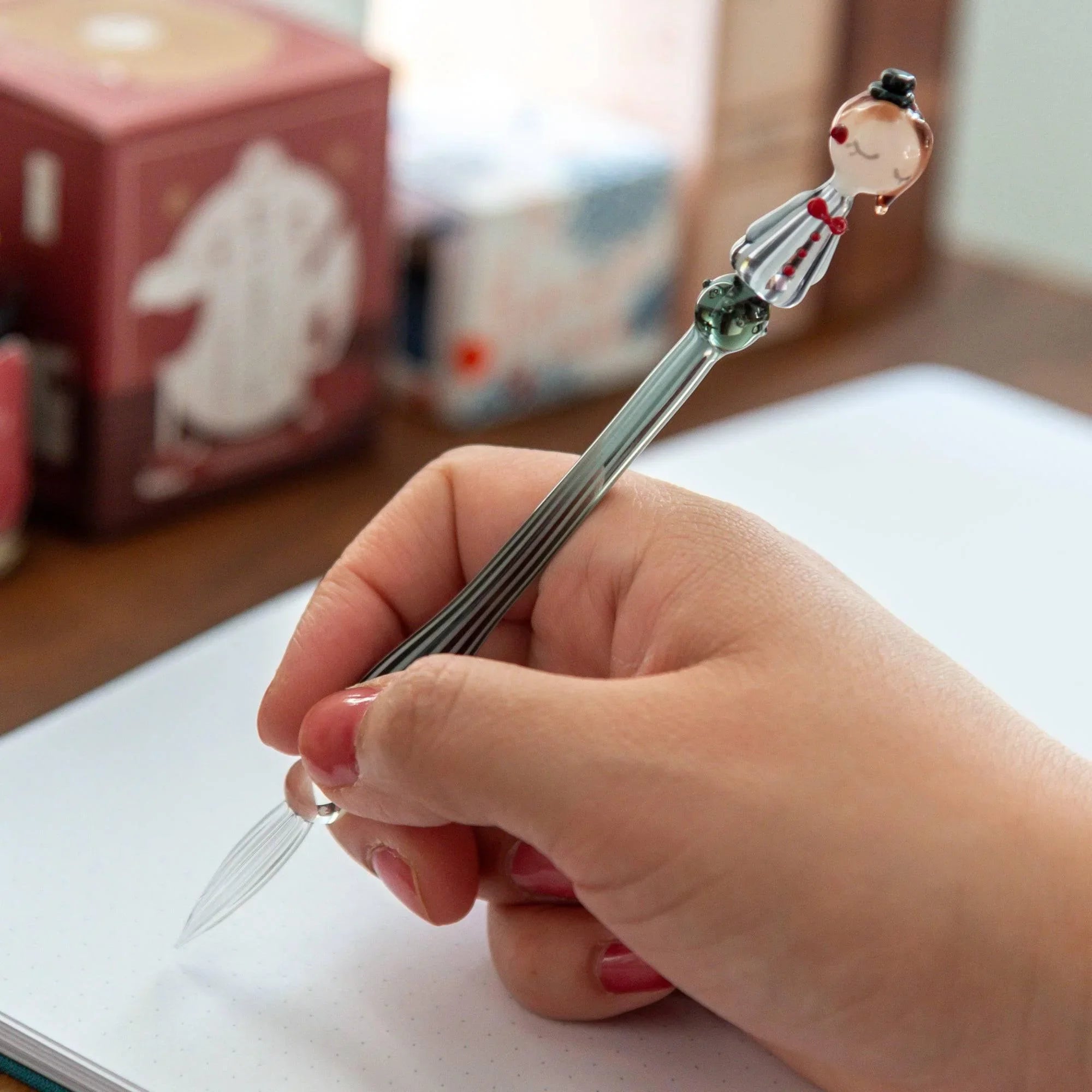 Fashionable Lady Moga-Chan glass pen in hand showing vintage character and gray striped barrel with handle detail and