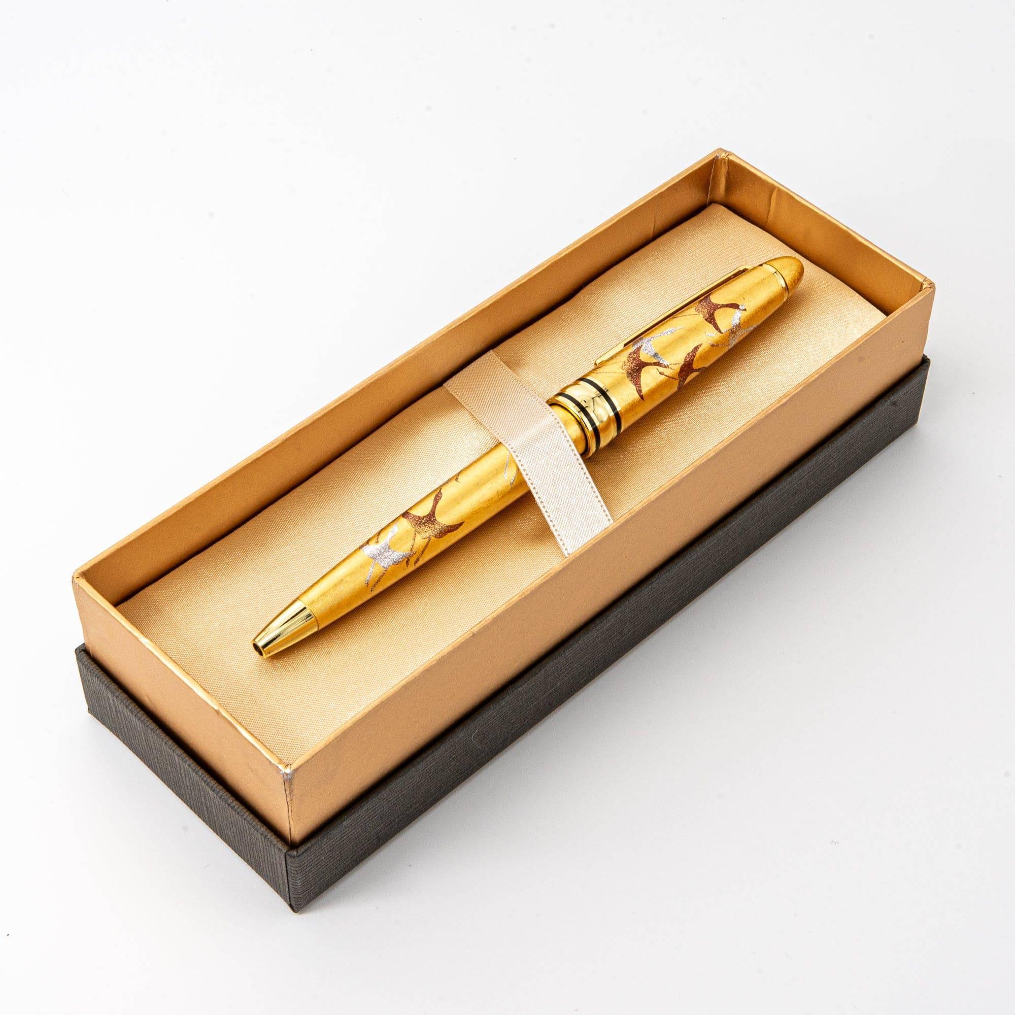 Angled view Gold Leaf Crane Makie ballpoint pen with crane flight composition rendered in gold and brown