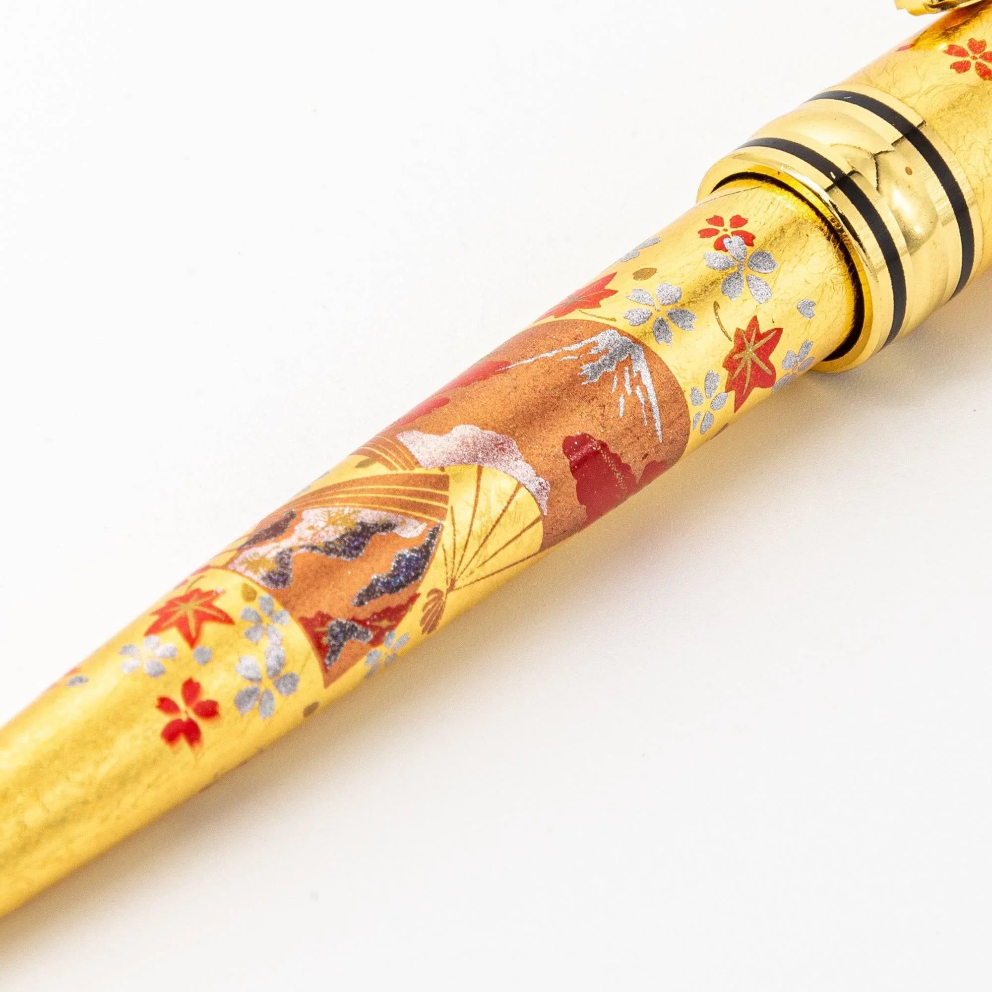Detail shot Gold Leaf Japanese Fan Makie ballpoint pen with black finish and gold fan pattern on barrel