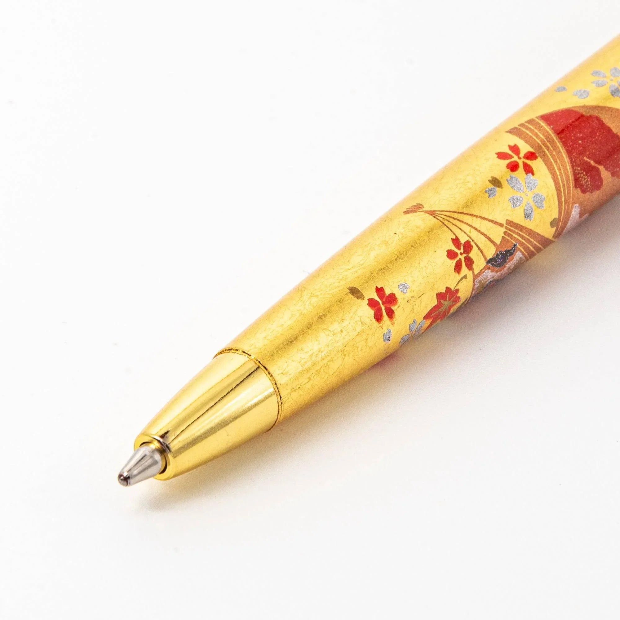Three-quarter angle Gold Leaf Japanese Fan Makie ballpoint pen with curved fan shape rendered in gold art