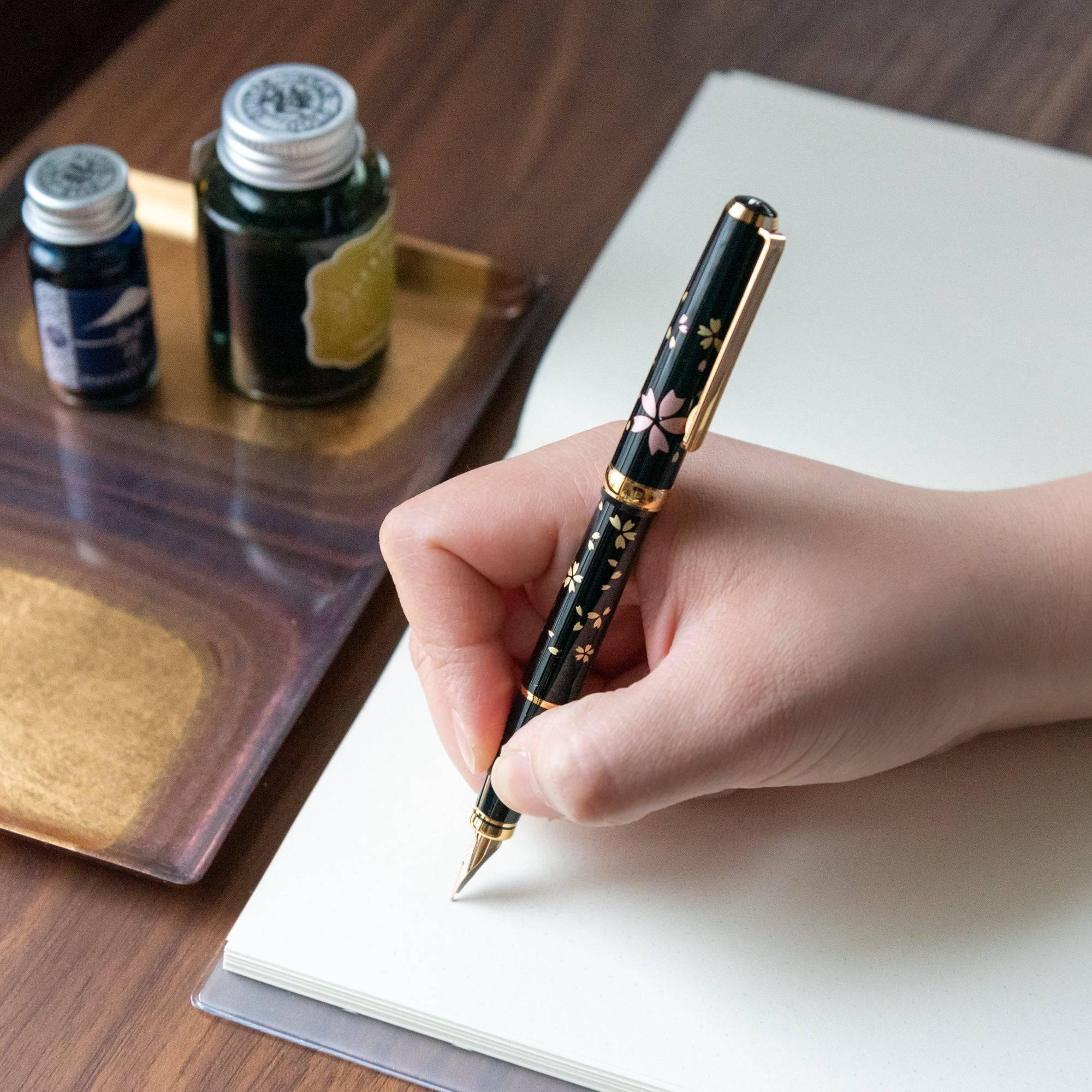 Sakura fountain pen with black lacquer barrel and scattered fine gold cherry blossom Makie detail design