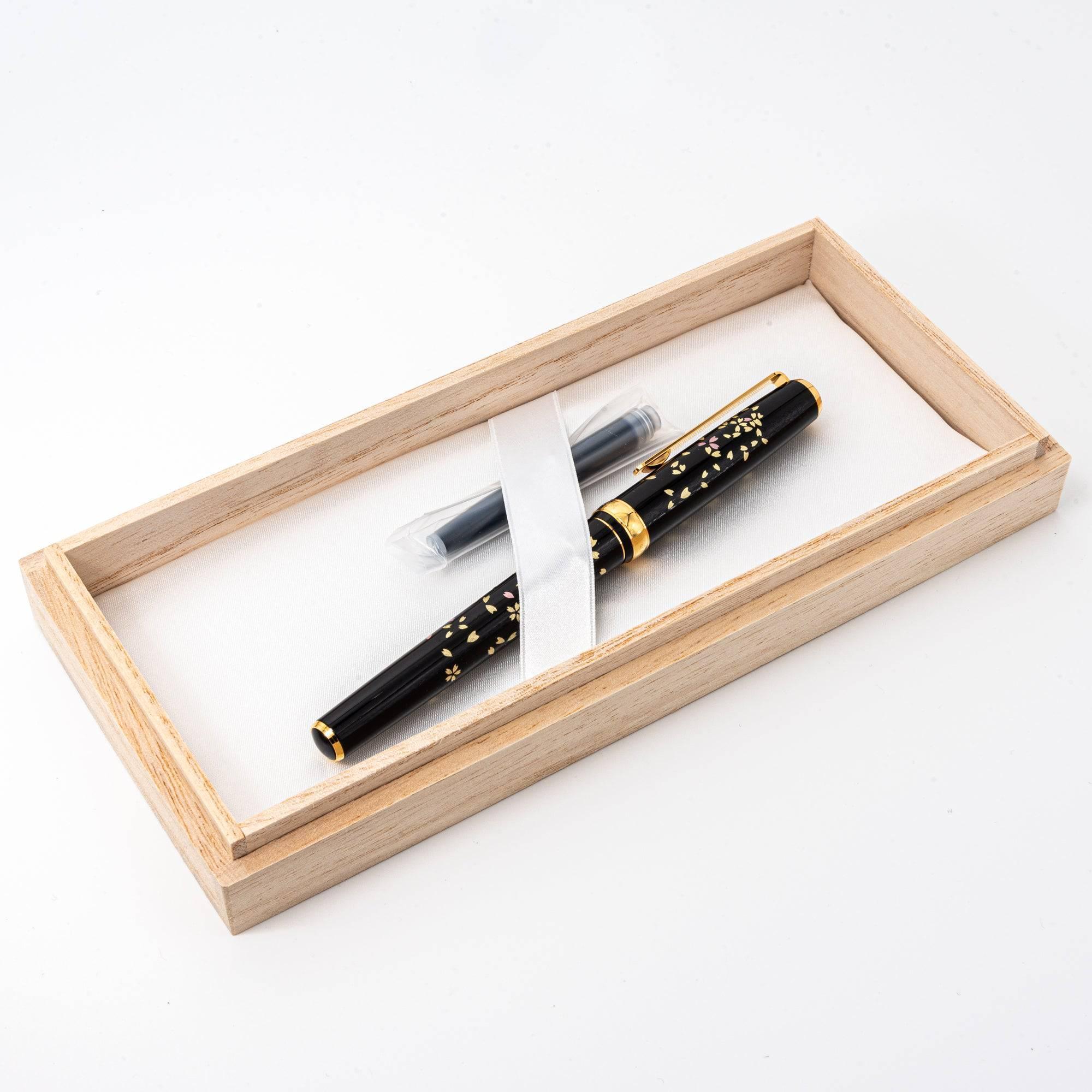 Side view Gold Leaf Makie Sakura fountain pen with pink and gold cherry blossoms on black lacquer base