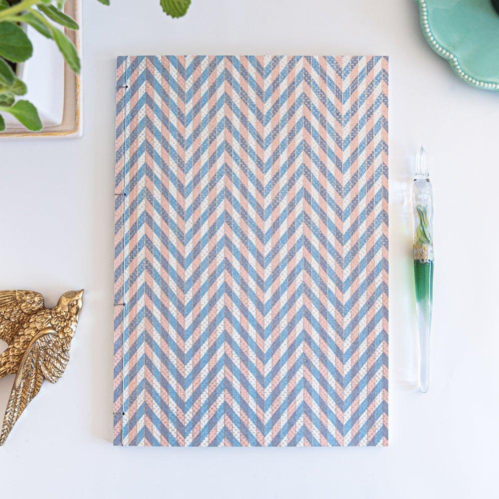 Light blue Yuzen washi notebook with Japanese stab binding, B5 size, showing dyed texture with quality binding and paper