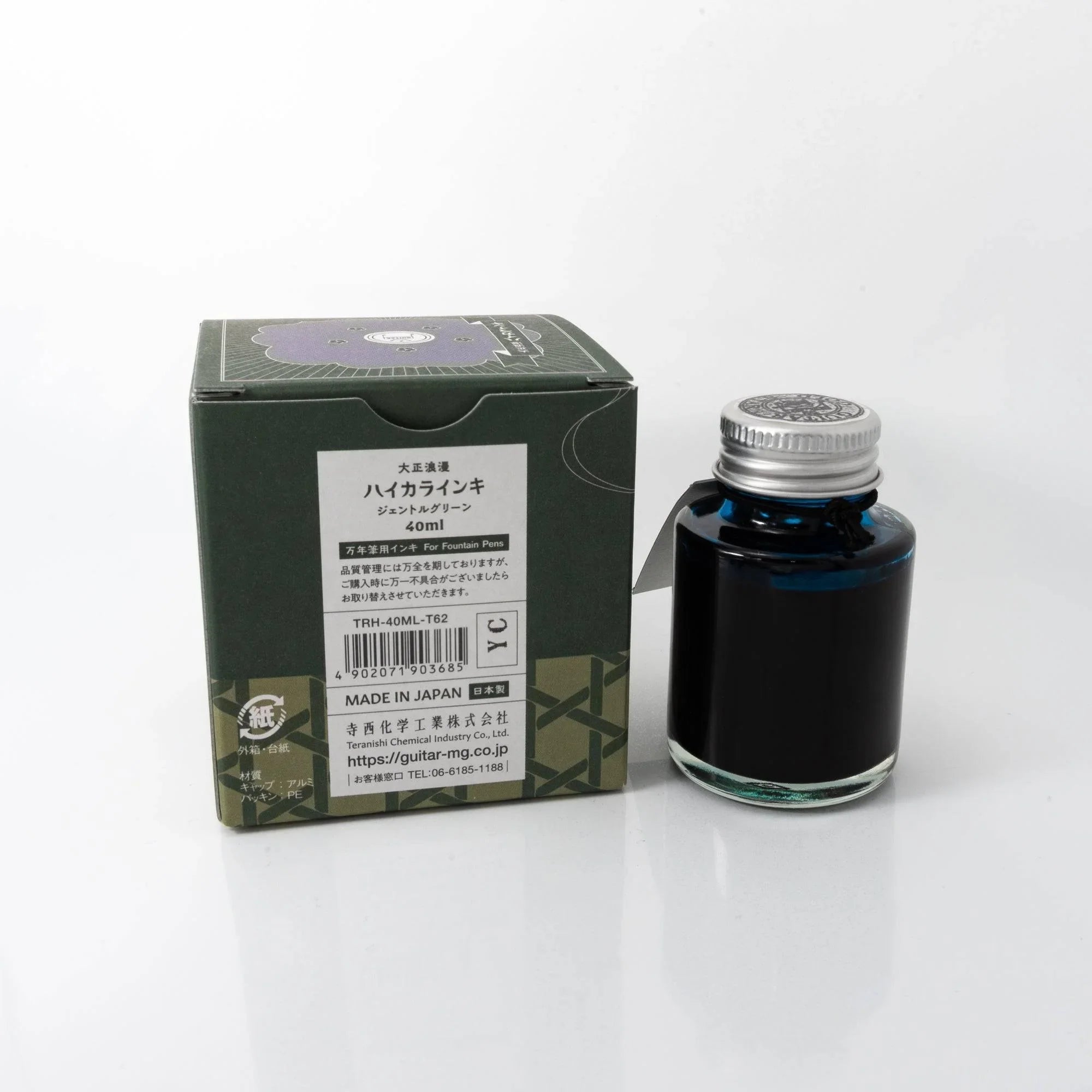 Taisho Romance Gentle Green ink bottle displayed with Japanese stationery accessories on styled flatlay surface