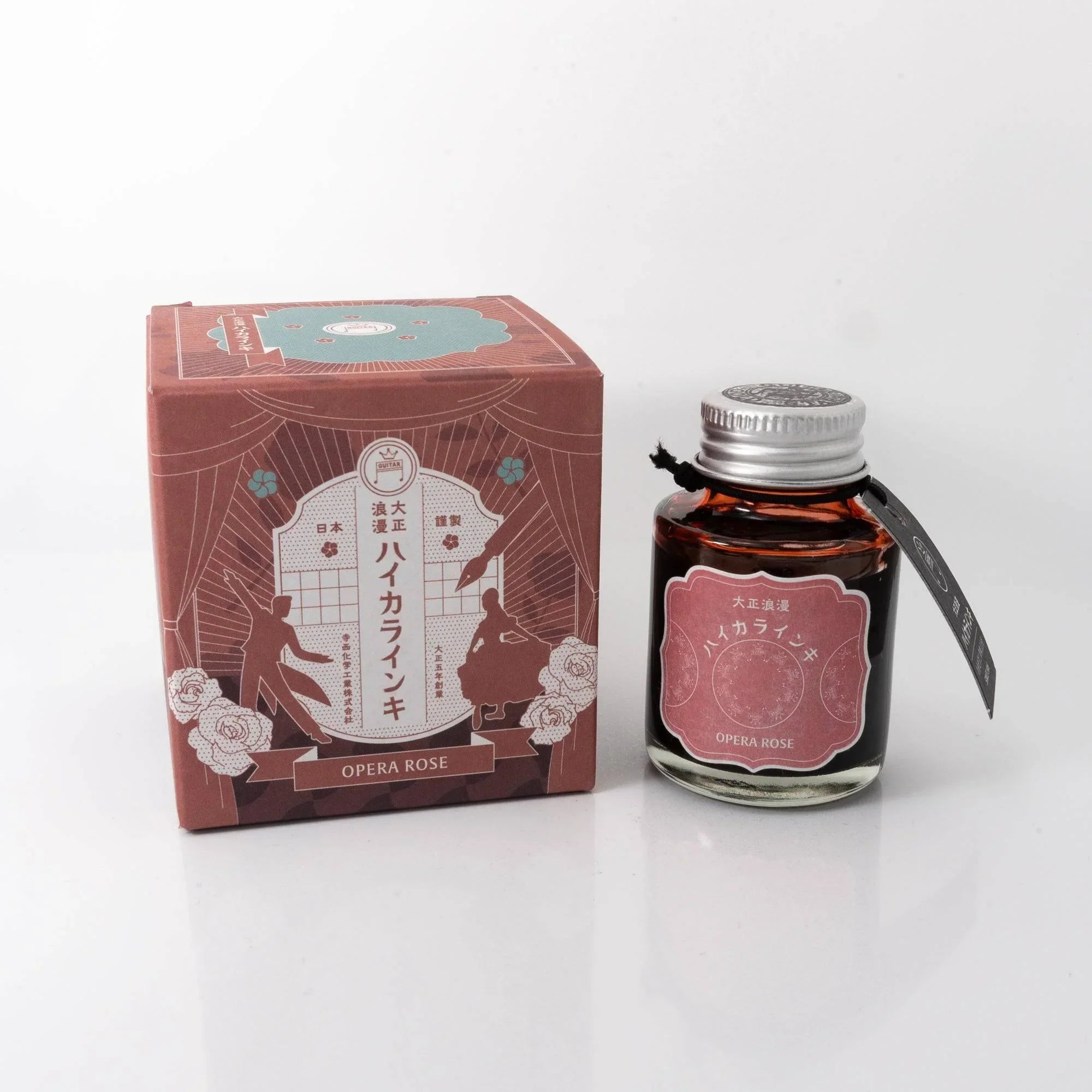 Taisho Romance Opera Rose fountain pen ink bottle and black burgundy box with rose-tone accents displayed