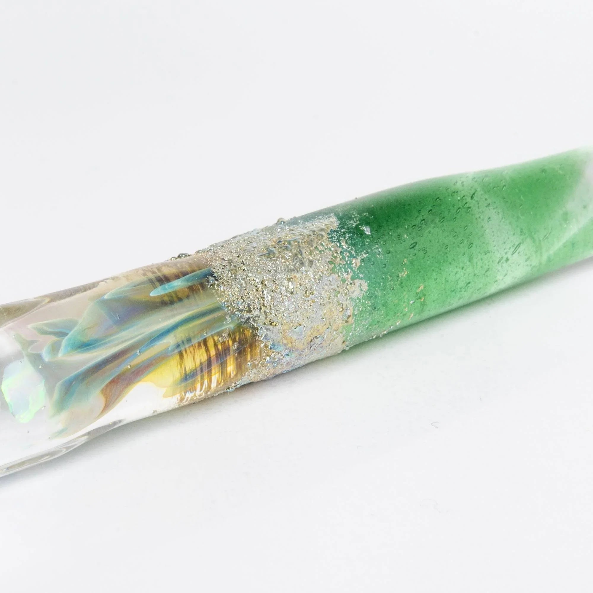 Tsukuyomi green glass dip pen being held while writing showing application of metal nib on white paper with holder