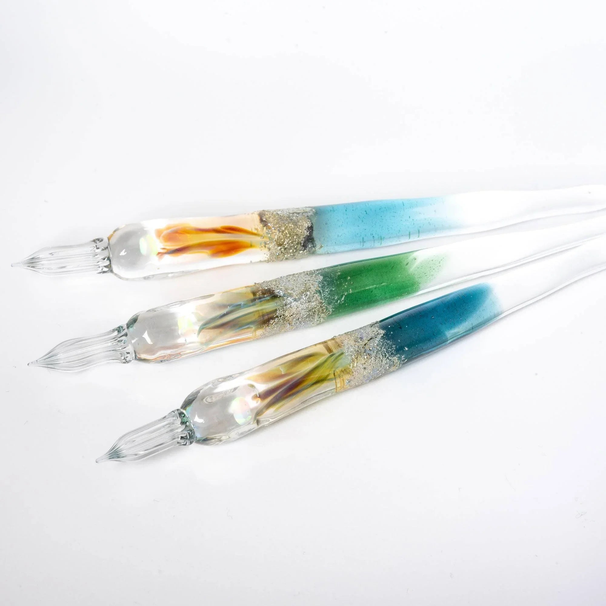 Tsukuyomi green glass dip pen resting position displaying deep green tone throughout barrel and metal ferrule shine