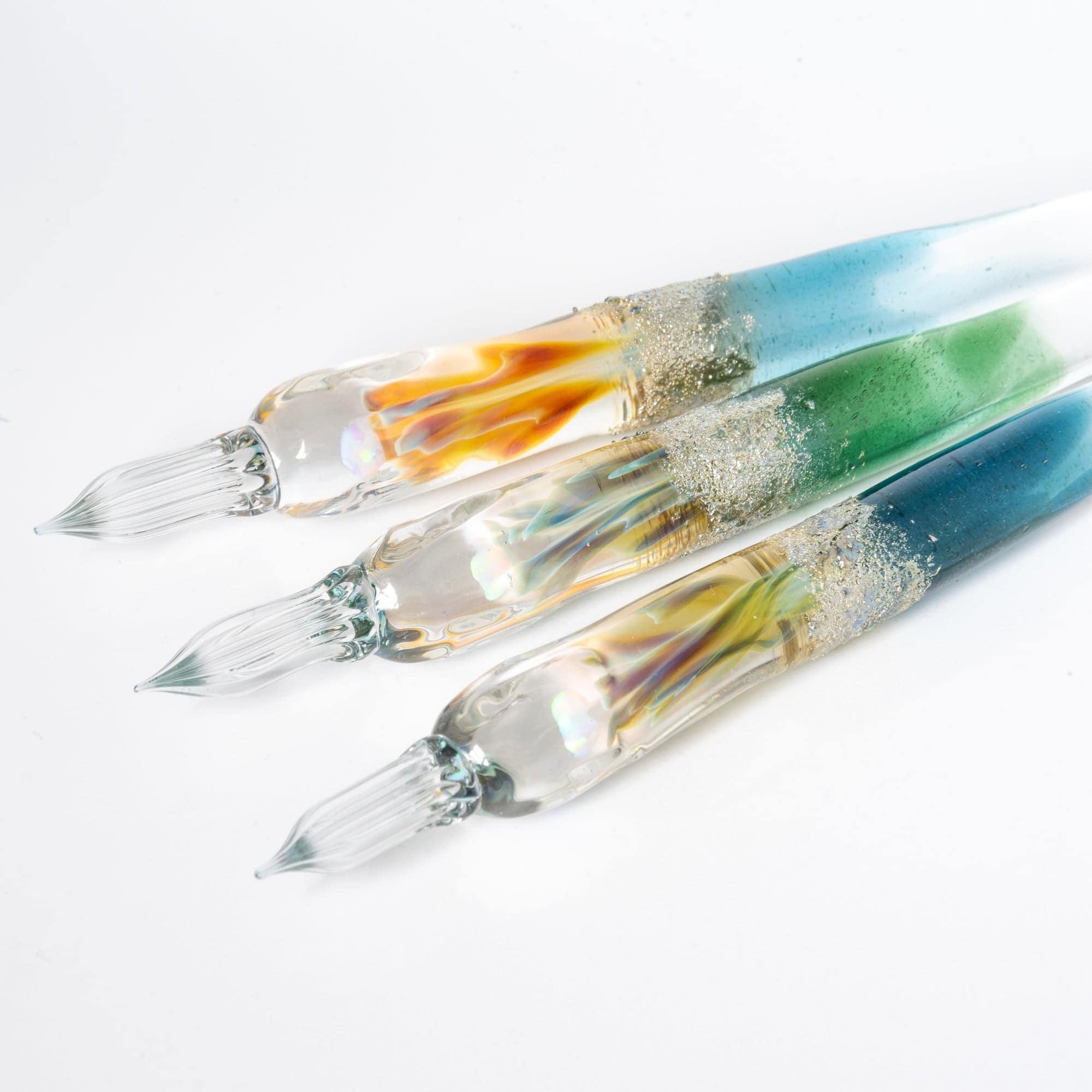 Overhead perspective of Tsukuyomi green glass dip pen showing nib alignment and green glass barrel texture shine