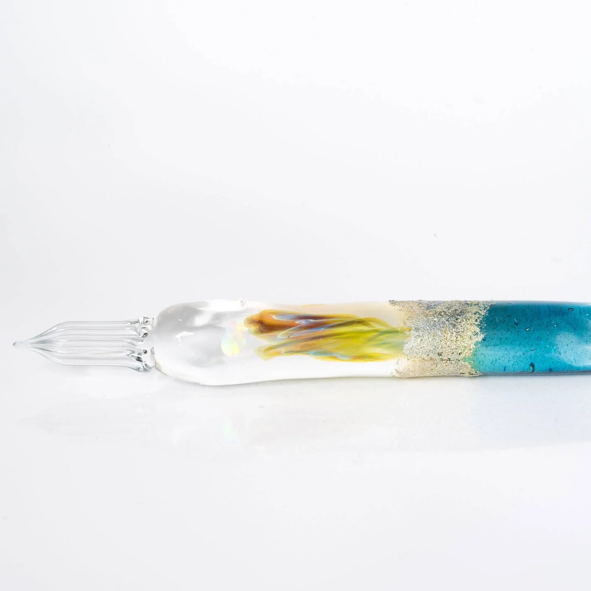 Isolated light blue glass Tsukuyomi dip pen displaying gentle translucent barrel with twisted glass nib shine