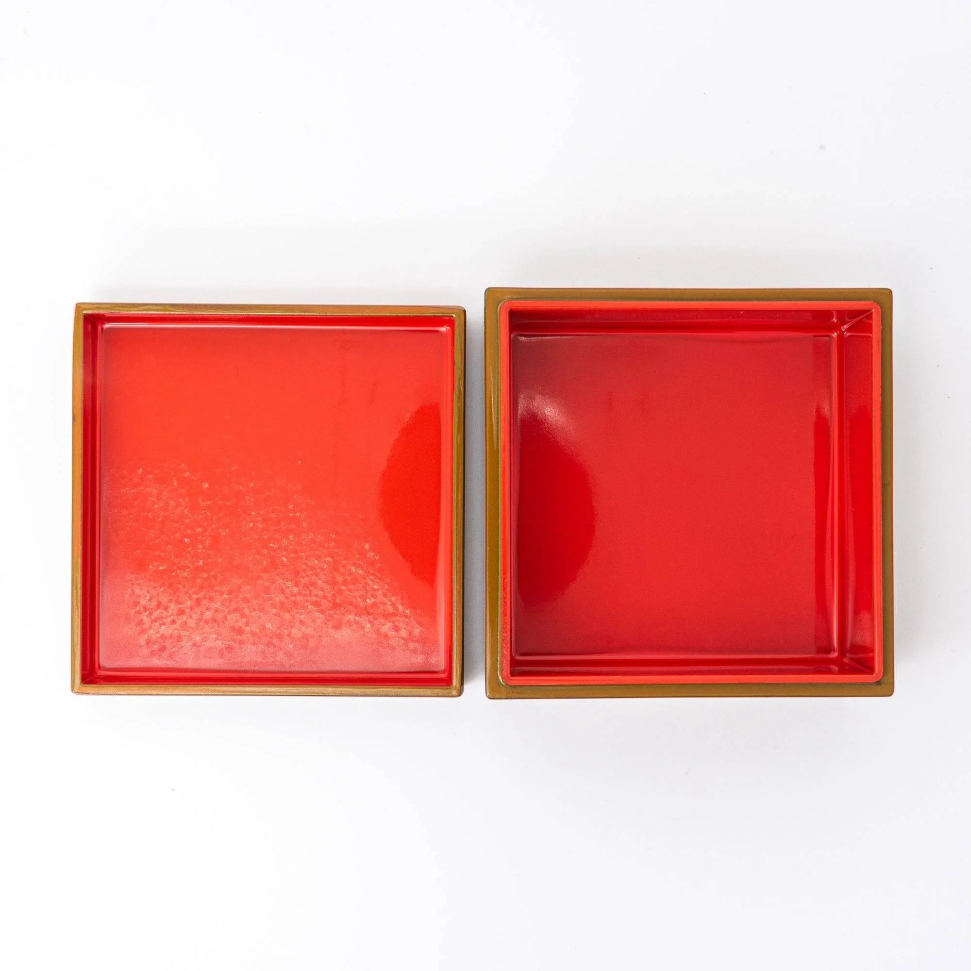 Two Japanese urushi lacquer boxes with bright red interior compartments and khaki lacquered exterior