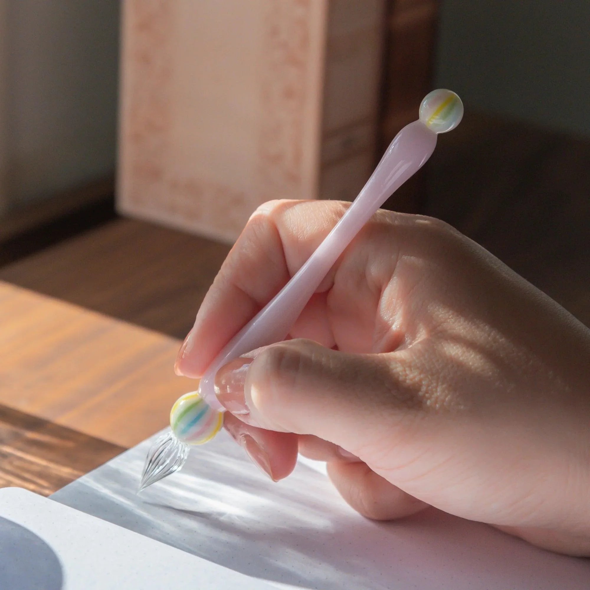 Wagashi Sakura Mochi glass dip pen showcasing Japanese-inspired coral red mochi-shaped top and pink glass handle